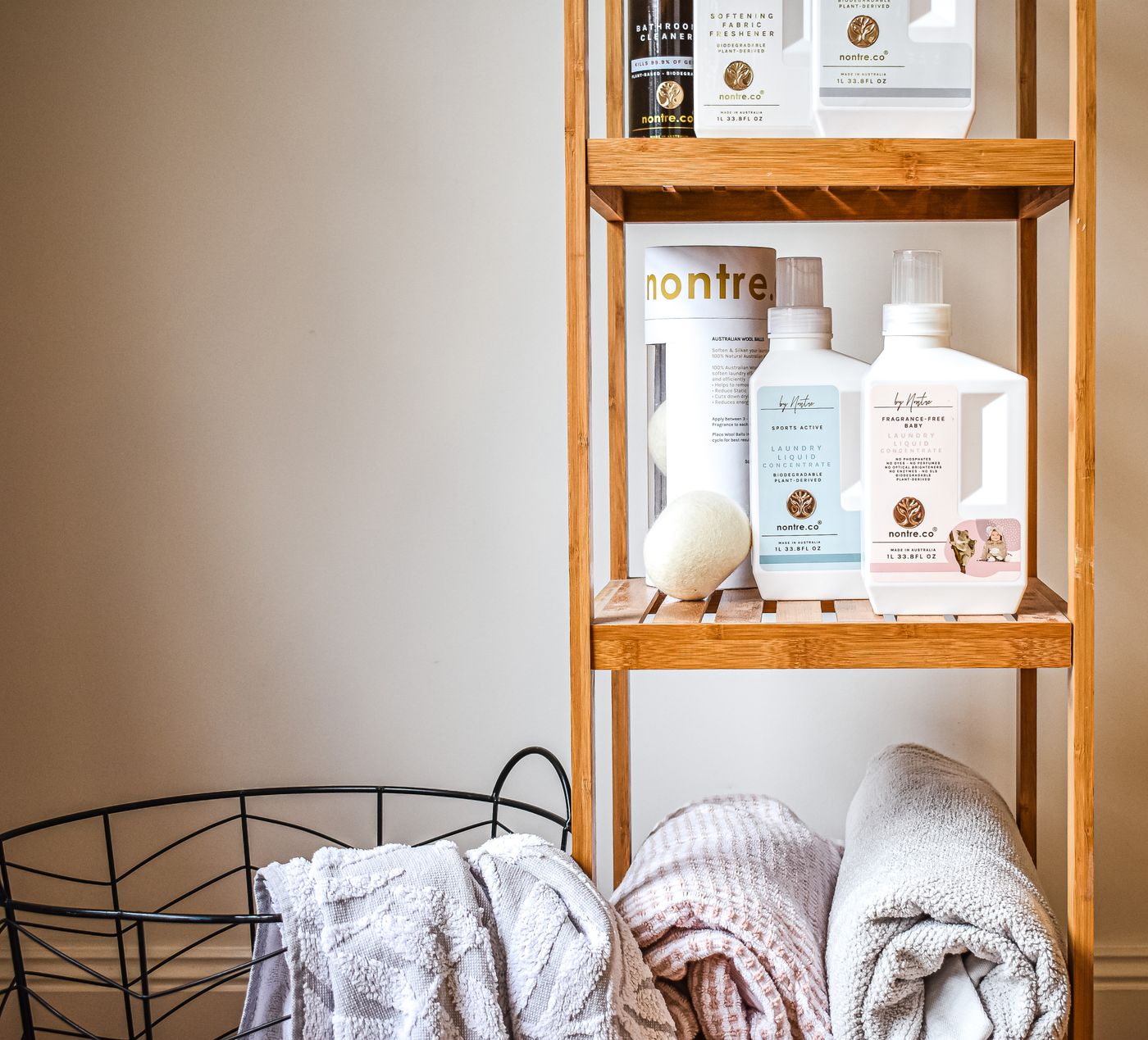 Towels and toiletries on bathroom shelves