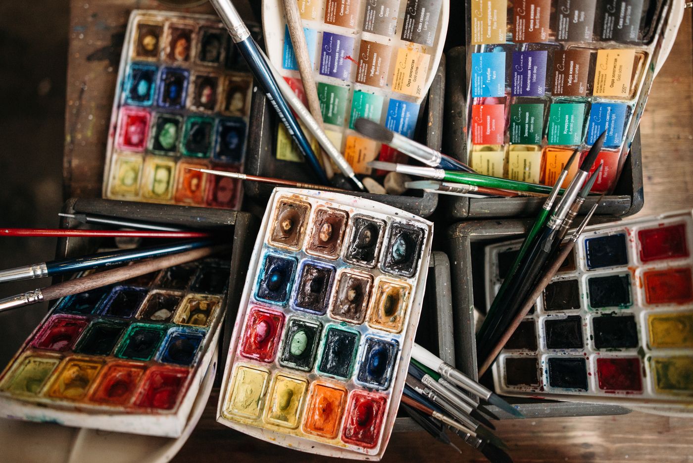 Watercolour palette and paintbrushes seen from above
