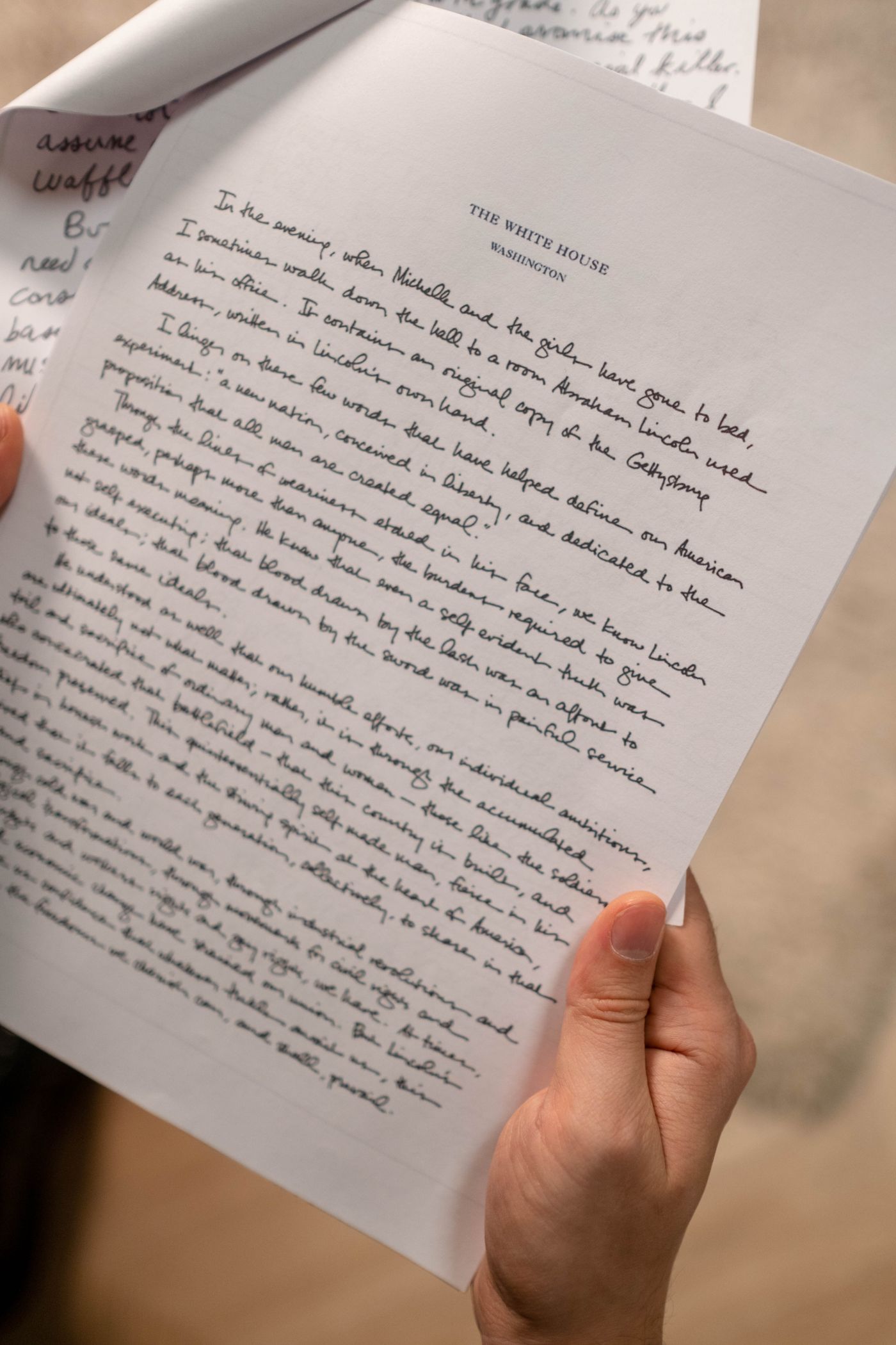 A handwritten letter held in a hand