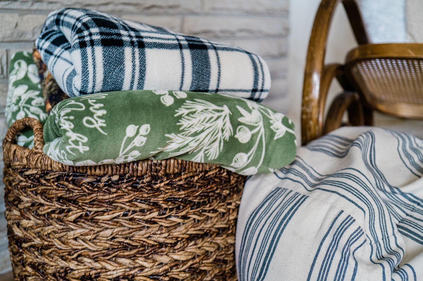 Folded blankets in a woven basket