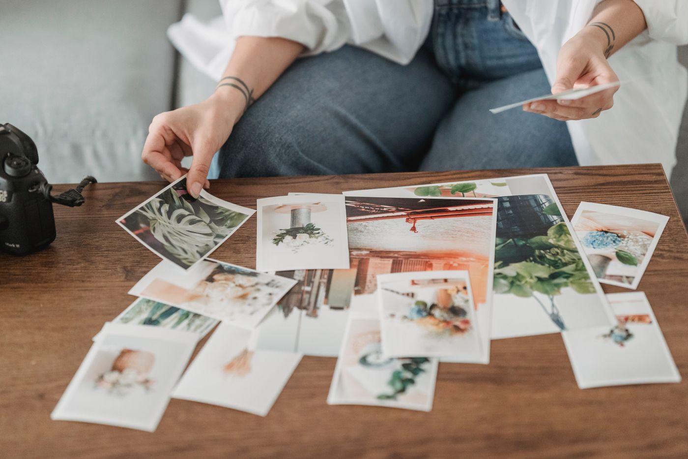 A person sorting photographs on a table