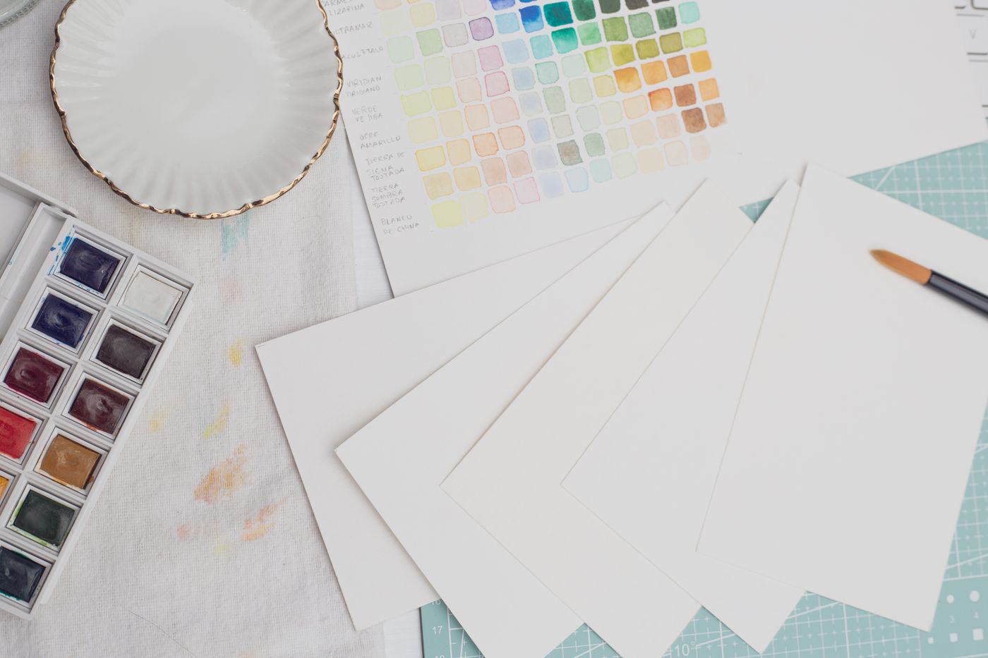 Paper and watercolour paint on a work surface
